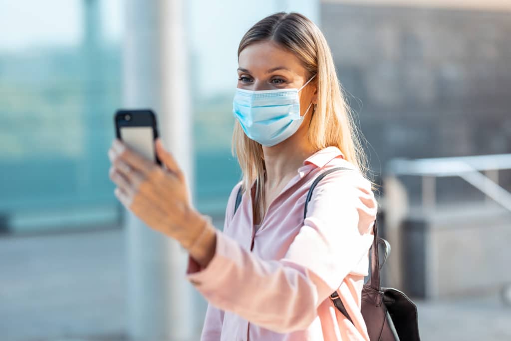 beautiful blonde woman in face mask doing a selfie RQS4Q33 1024x683 1