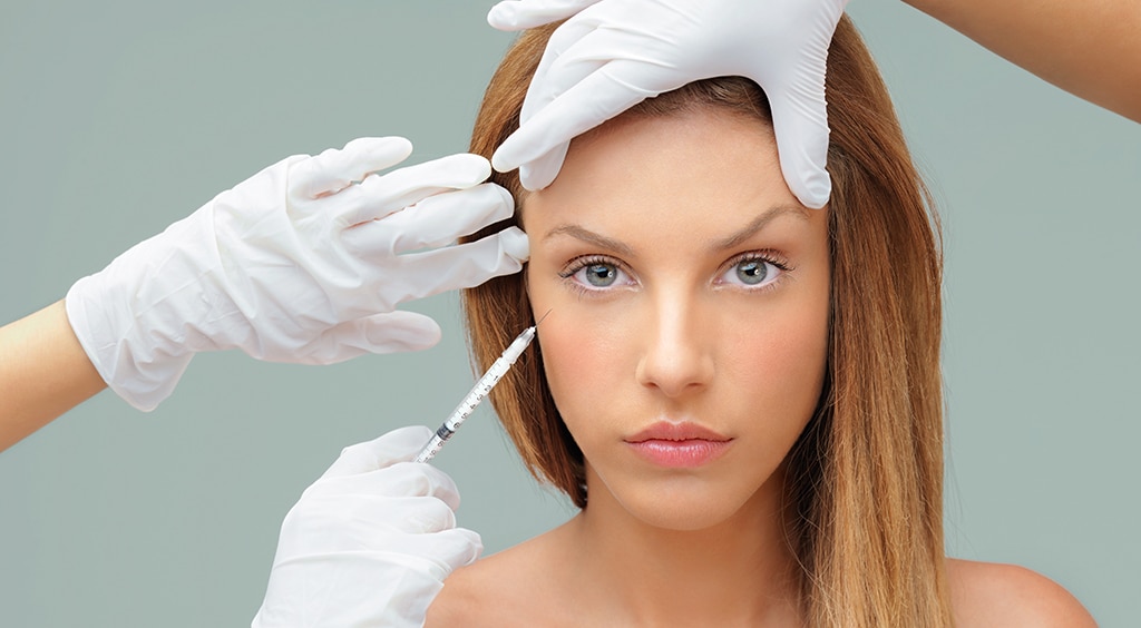 young woman with doctor hands injecting botox PVKHPRX